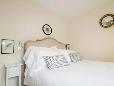 a bedroom with a white bed with two pillows at Pirata in St Austell