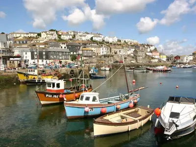 a group of boats are docked in a harbor at Pirata in St Austell