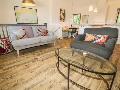 a living room with a couch and a glass table at Pirata in St Austell