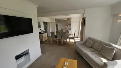 a living room with a couch and a flat screen tv at Heathfield in Saint Mawes
