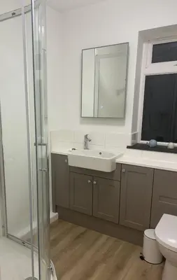 a bathroom with a sink and a mirror and a toilet at Heathfield in Saint Mawes
