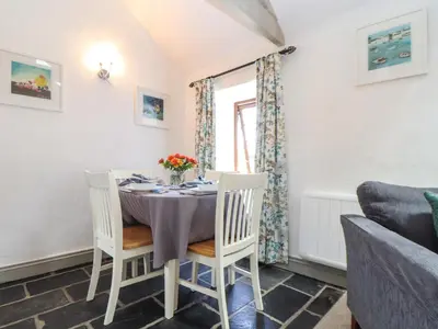 a dining room with a table and chairs at Little Riviere in Hayle