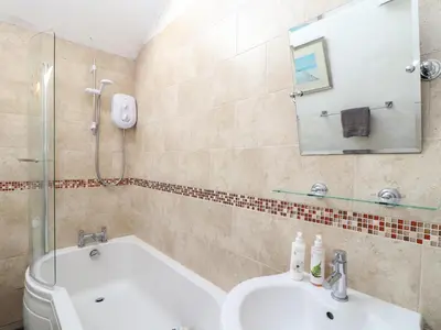 a bathroom with a toilet and a sink and a shower at Little Riviere in Hayle