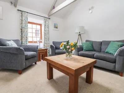 a living room with two couches and a coffee table at Little Riviere in Hayle