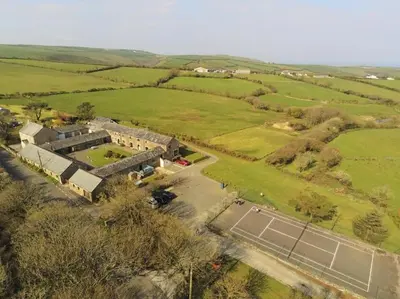 an aerial view of a building with a tennis court at The Stables - Crackington Haven Cornwall in Crackington Haven