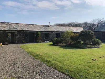 an old stone house with a grass yard at The Stables - Crackington Haven Cornwall in Crackington Haven