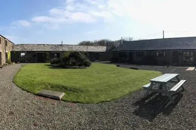 a picnic table sitting in the middle of a yard at The Stables - Crackington Haven Cornwall in Crackington Haven