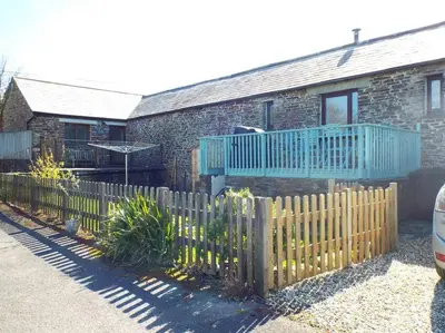 a wooden fence in front of a house at The Stables - Crackington Haven Cornwall in Crackington Haven