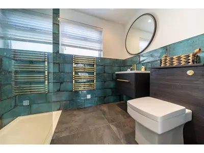 a bathroom with a toilet and a mirror at Gwel An Keynvor Penthouse in Newquay