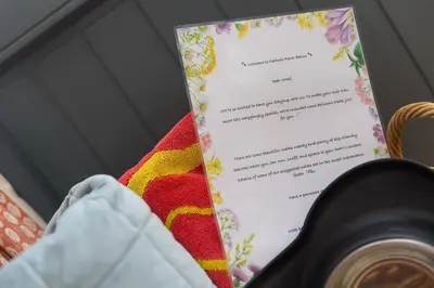 a menu on top of a table with a camera at Carines Barns - Tre in Newquay