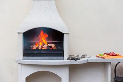 a brick oven with a fire in it at Carines Barns - Tre in Newquay