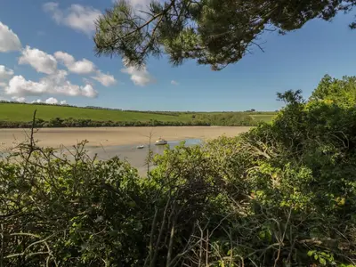 a view of a river with a boat in it at Carines Barns - Tre in Newquay