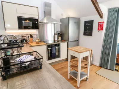 a kitchen with a sink and a counter top at Carines Barns - Pol in Newquay