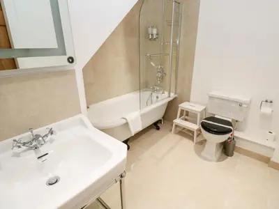 a bathroom with a sink and a toilet and a shower at Carines Barns - Par in Newquay