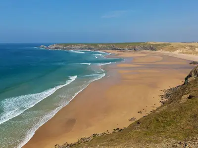 an aerial view of a beach with the ocean at Carines Barns - Par in Newquay