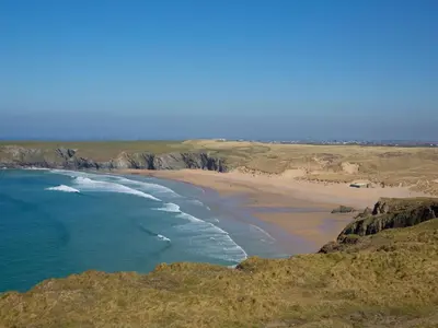 an aerial view of a beach with the ocean at Carines Barns - Par in Newquay