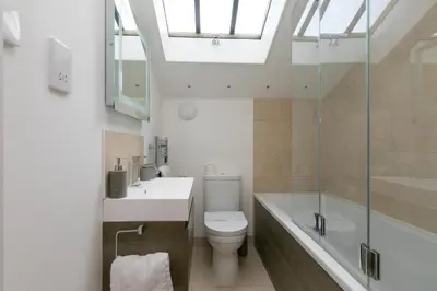 a bathroom with a toilet and a sink and a bath tub at Carines Barns - Pen in Newquay