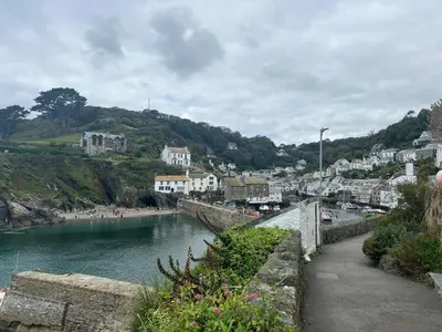 a body of water next to a town with houses at The Captain's House in Looe