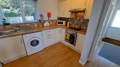 a kitchen with a washing machine and a sink at Polmaro in Saint Mawes