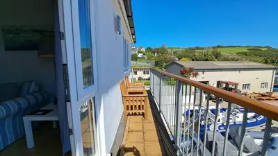 a balcony with a view of a yard at Polmaro in Saint Mawes