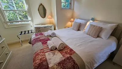 a bedroom with a large bed with towels on it at Pennant in Saint Mawes