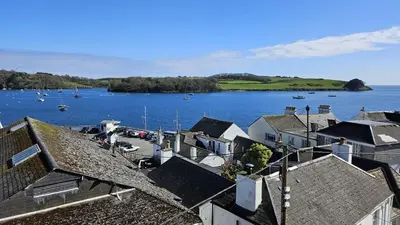a group of houses and a body of water with boats at Pennant in Saint Mawes