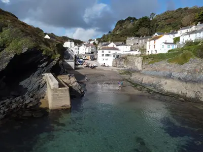 a view of a beach with houses and water at Beach Hill Cottage in Portloe