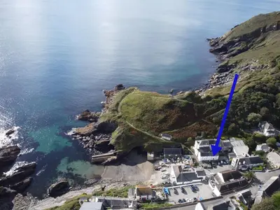 an aerial view of a village on a hill with the ocean at Beach Hill Cottage in Portloe