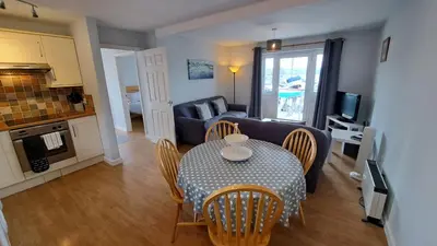 a living room with a table and a couch at Pelyn in Saint Mawes