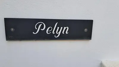 a sign on a wall with the word relivan on it at Pelyn in Saint Mawes