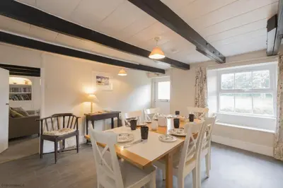 a dining room with a table and chairs at April Cottage in Saint Just in Roseland