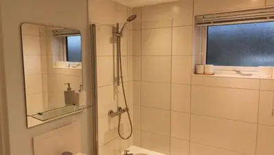 a bathroom with a shower with a glass door at Valley View Lodges in Liskeard