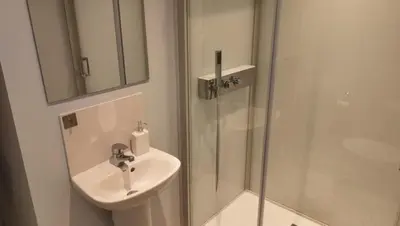 a white bathroom with a sink and a shower at Valley View Lodges in Liskeard