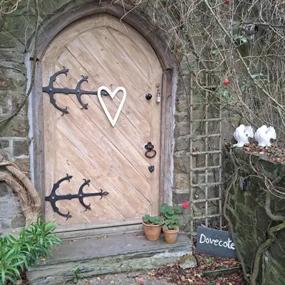 a wooden door with a heart painted on it at The Dovecote in Launceston