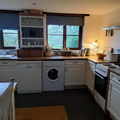 a kitchen with a washer and dryer in it at The Dovecote in Launceston