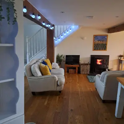 a living room with a couch and a fireplace at The Dovecote in Launceston