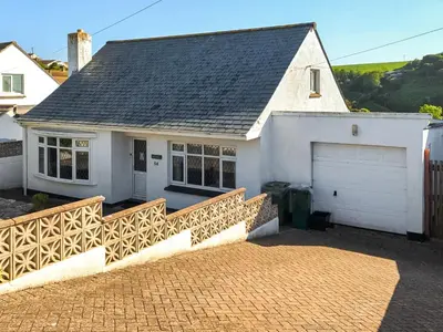 a white house with a gate and a garage at Kylden in Port Isaac