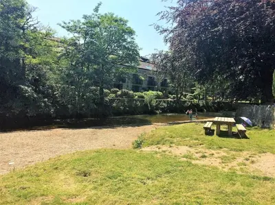 a picnic table in the grass in a park at Chy Bownder Cottage in Lostwithiel
