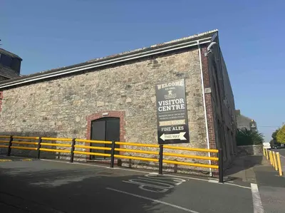 a building with a sign on the side of it at Bells Cottage - Explore Cornwall by rail in St Austell