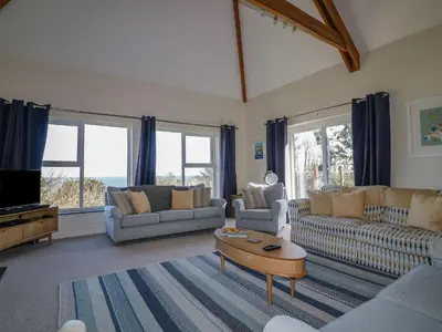 a living room with two couches and a coffee table at Lower Mellan Barn in Helston
