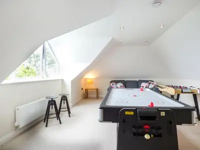 a room with a ping pong table in a attic at Lower Mellan Barn in Helston