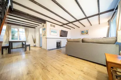 a living room with a couch and a fireplace at Hebaska~Watergate Bay~3 Bedroom in Porth