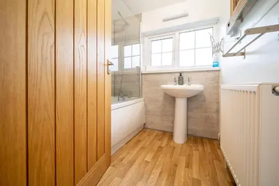 a bathroom with a white sink and a window at Hebaska~Watergate Bay~3 Bedroom in Porth