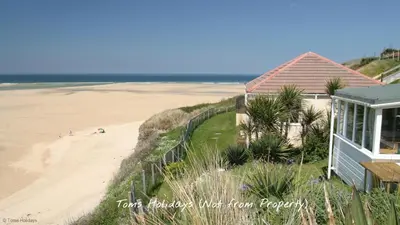 a house on the beach next to a sandy beach at C35 Le Grace, Riviere Towans in Hayle