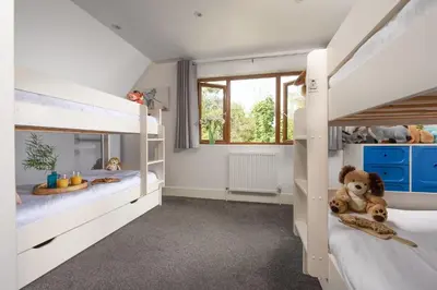 a kids bedroom with two bunk beds and a window at Robins Rest - Pets welcome - Free Parking - Backgarden in Perranporth