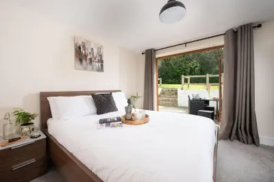 a bedroom with a large bed and a large window at Robins Rest - Pets welcome - Free Parking - Backgarden in Perranporth