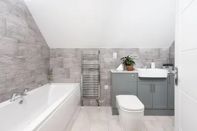 a bathroom with a tub and a toilet and a sink at Robins Rest - Pets welcome - Free Parking - Backgarden in Perranporth