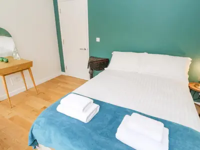 a bedroom with a large bed with towels on it at James' Place in Falmouth