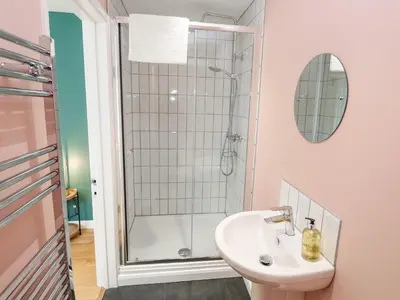 a bathroom with a sink and a shower at James' Place in Falmouth