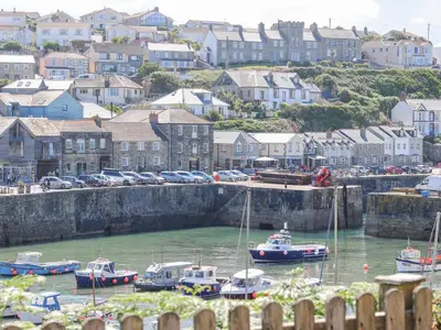 a group of boats in the water in a harbor at Crab Pot Cottage in Helston